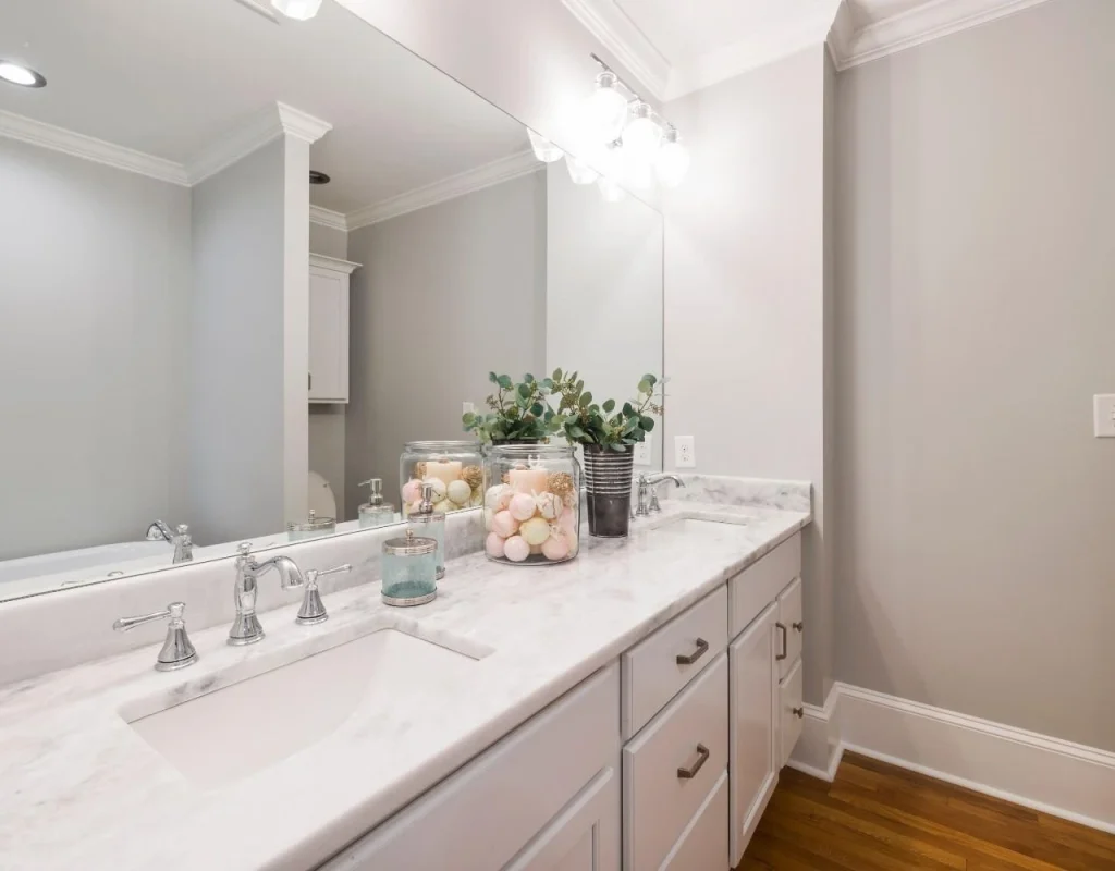 Custom powder room design featuring coordinated wall finishes, vanity, and decorative details in New Lenox, IL.